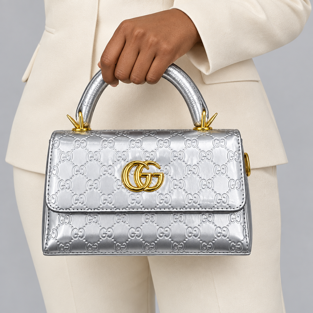 Metallic silver embossed handbag held by a model
