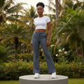 Nigerian female model wearing women's dark grey tailored flared palazzo trousers elegant style