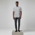 Nigerian male model wearing white black dalmatian print short-sleeved shirt, front view
