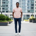 Young Nigerian male model wearing blush pink laurel crest print polo shirt