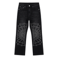 Black wide-leg jeans with white outlined spiderweb designs on both legs