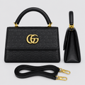 Black embossed handbag front and side views with matching strap