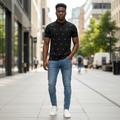 Young Nigerian male model wearing black flying bird print polo shirt