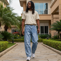 Nigerian male model wearing light blue baggy rhinestone pearl stud embellished denim jeans