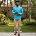 Young Nigerian male wearing vibrant turquoise plain linen long sleeve button-down shirt