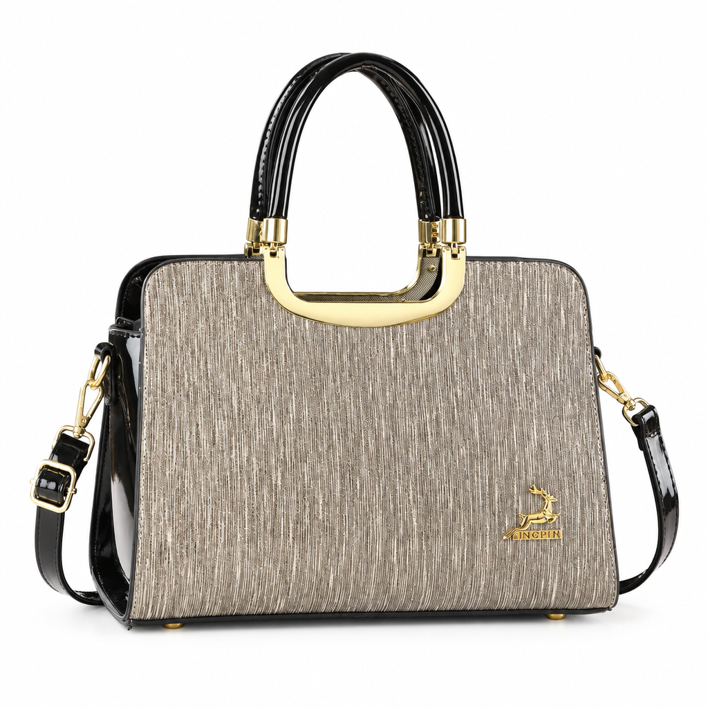 Champagne textured structured handbag with black handles and gold-tone accents on white