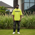 Nigerian male model wearing neon yellow oversized graphic print tee