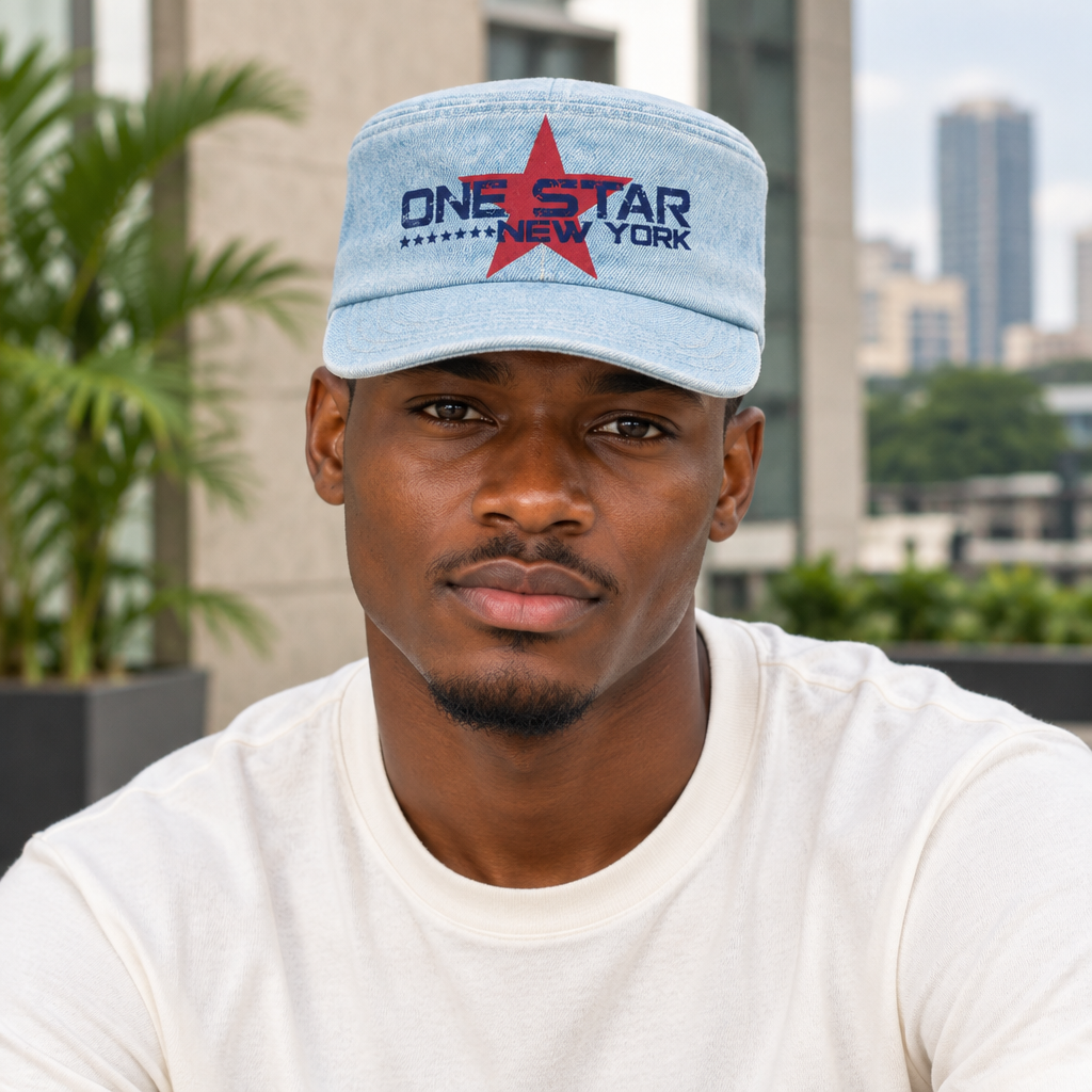 Young Nigerian man wearing light wash denim cadet cap with red star graphic