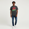 Young Nigerian male wearing dark charcoal JLS Legacy Meets Style graphic tee