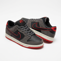 Pair of black and charcoal-grey low-top sneakers with red trim on white