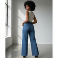 Nigerian female model wearing medium blue palazzo wide-leg jeans back view