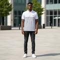 Young Nigerian male model wearing white polo shirt with navy horizontal stripes