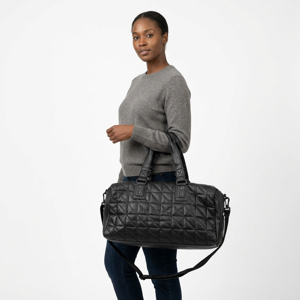 Adult woman carrying a black quilted duffle bag