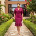 Nigerian female model wearing magenta wrap midi dress with ruffle hem