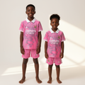 Black Nigerian boy and girl wearing Real Madrid FC kids pink dragon special edition football kit