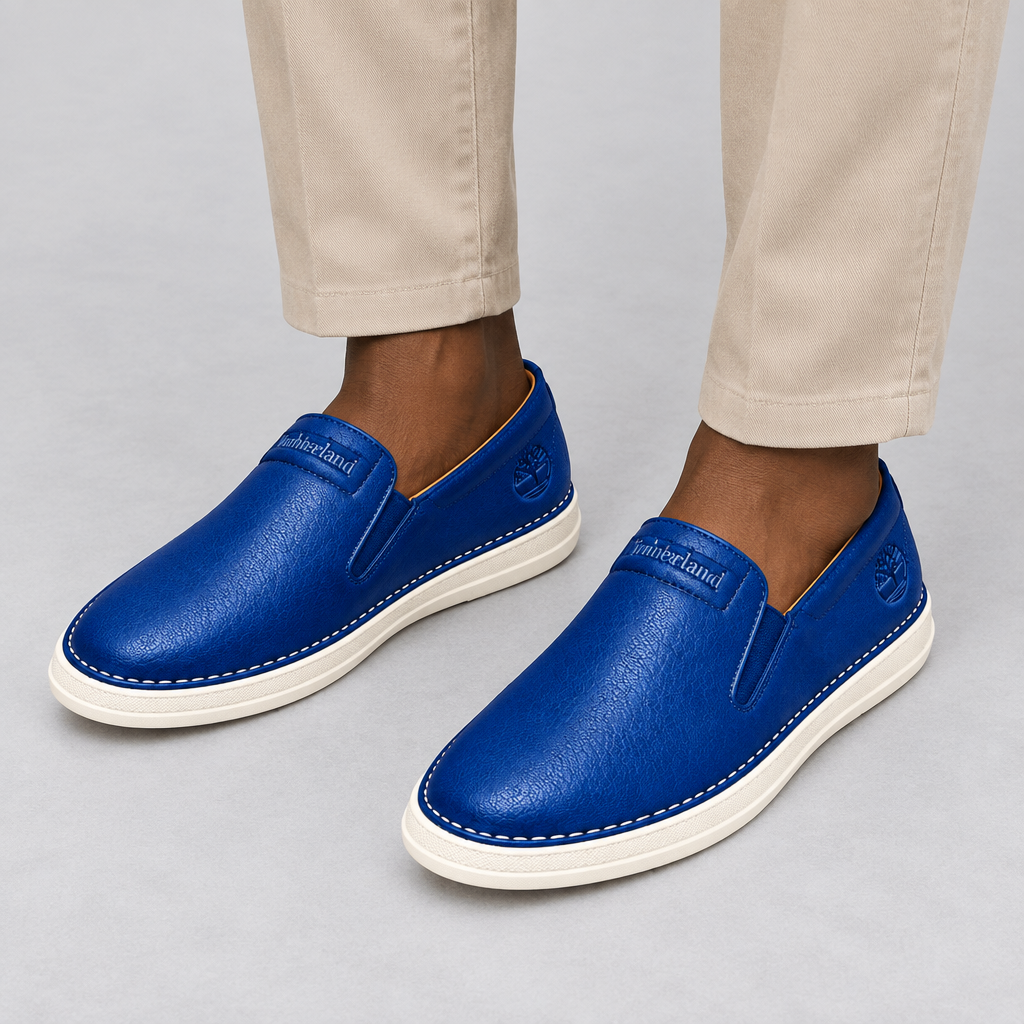 Royal blue slip-on shoes worn with beige trousers