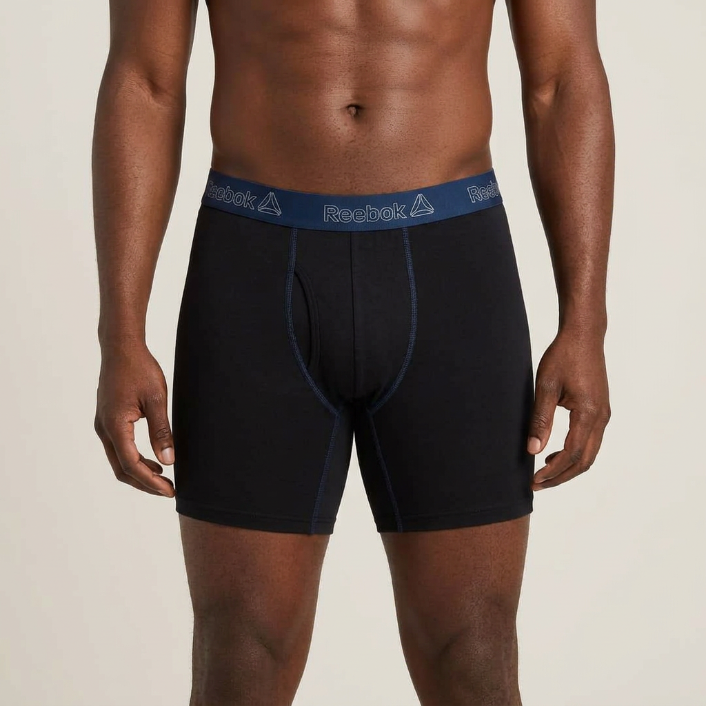 Male model wearing only black contrast seam boxer briefs with blue waistband