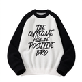 White slogan-graphic knit sweater with black raglan sleeves and crew neckline