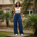 Nigerian female model wearing women's navy blue high-waist extra wide-leg palazzo denim jeans, garden setting