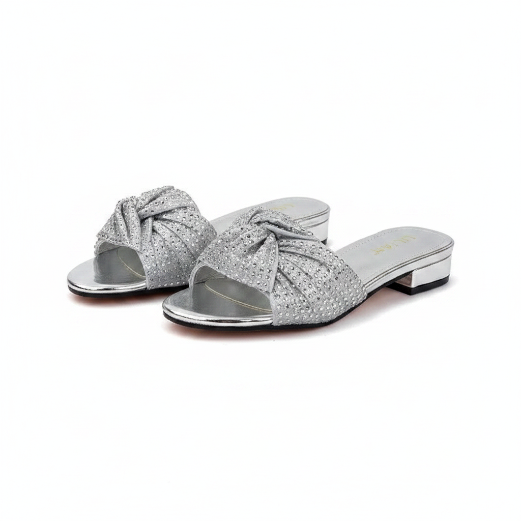 Ghost mannequin pair view of silver rhinestone bow block heel slide mules