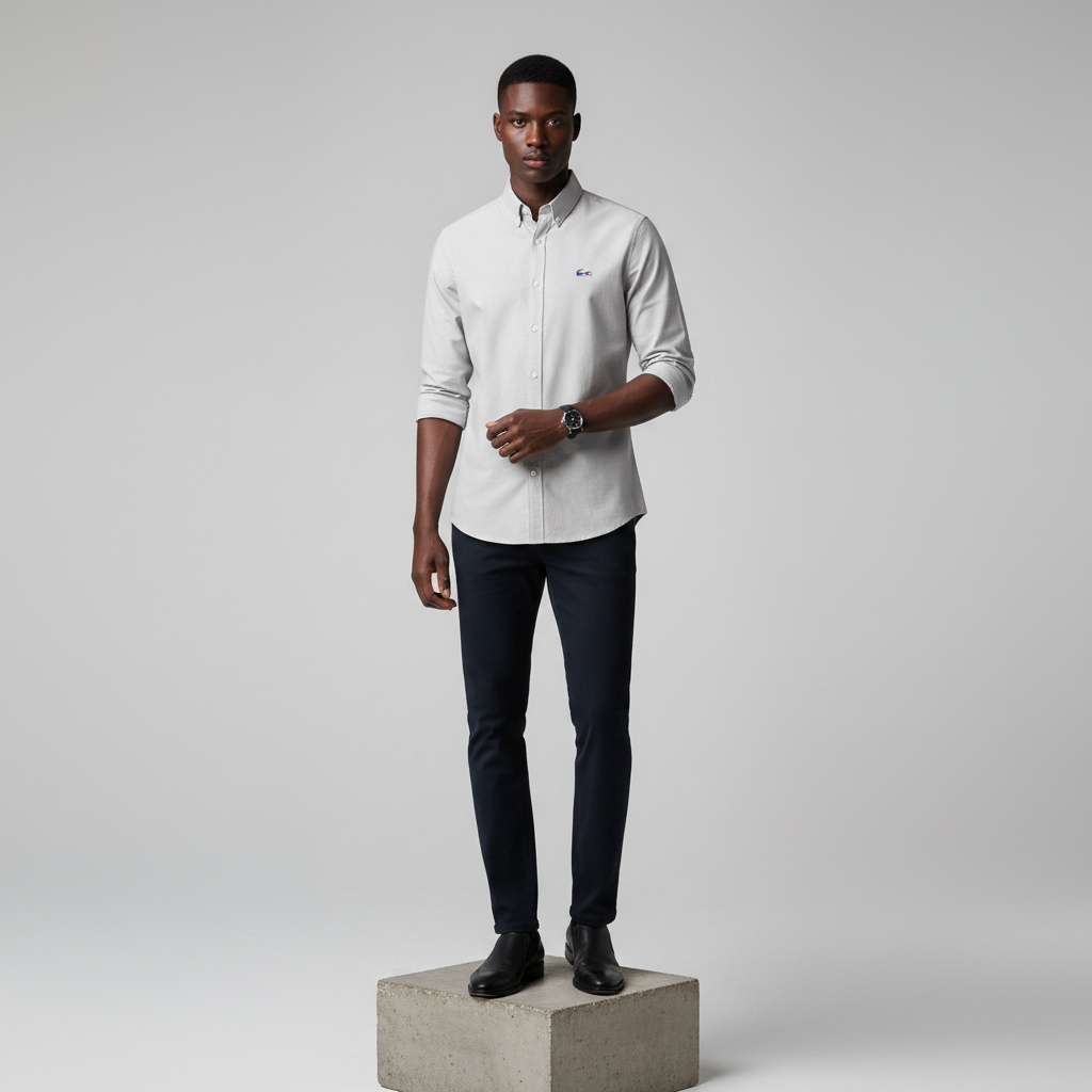 Nigerian male model wearing light grey plain long-sleeved shirt, front view