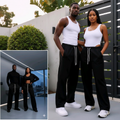 African Nigerian couple wearing unisex black wide-leg jogger trousers with drawstring waist