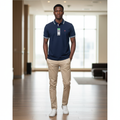 Young Nigerian male model wearing navy blue tipped polo shirt with white and red stripe collar and cuffs