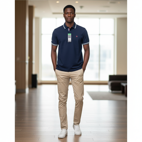 Young Nigerian male model wearing navy blue tipped polo shirt with white and red stripe collar and cuffs