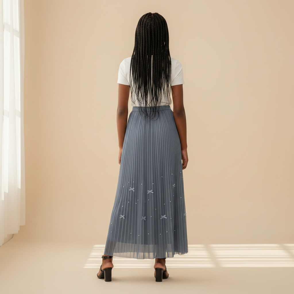 Nigerian girl wearing steel blue bow pleated midi skirt - back view