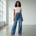 Nigerian female model wearing blue wide-leg jeans with pink flower appliques front view