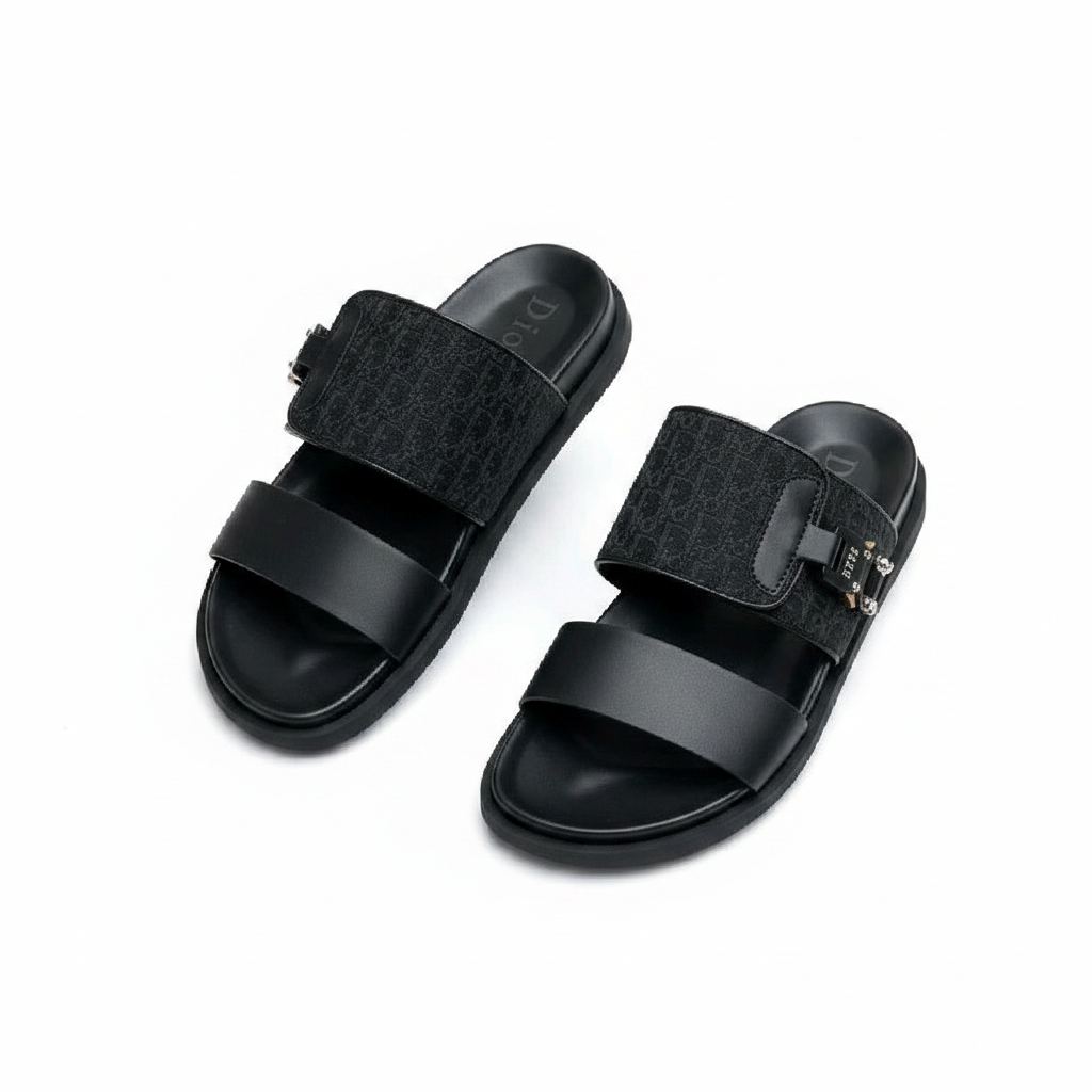 Men's all-black embossed double-strap slide sandals with metal clasp hardware, ghost mannequin pair view on white background