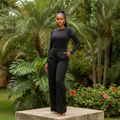 Nigerian female model wearing black long-sleeve rhinestone embellished bodysuit — full body shot