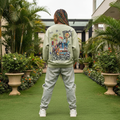 Nigerian female model wearing sage green illustrated cartoon bus graphic sweatshirt – back view