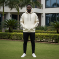 Oversized cream hoodie front view on Nigerian male model