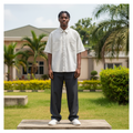 Nigerian male model full body wearing men's white pinstripe boxy short-sleeve shirt