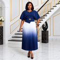 Black woman wearing navy-and-white ombré pleated ruffle dress