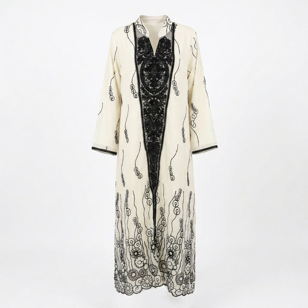 Cream and black ornate-panel abaya on an invisible mannequin against white