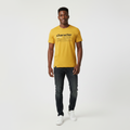 Young Nigerian male wearing mustard yellow Character definition typographic graphic crew neck tee