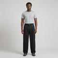 Full-body male model wearing black cord-detail wide-leg trousers