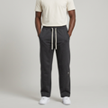 Adult Black model wearing charcoal straight-leg joggers with cream drawstrings and number detail