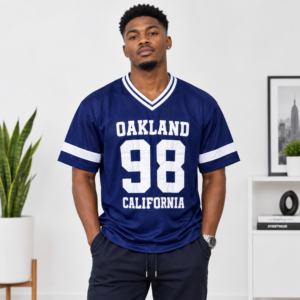 Young Black Nigerian man wearing Oakland 98 California navy mesh varsity jersey