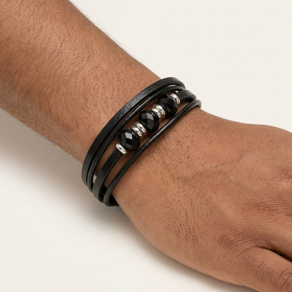 Black layered faceted-bead bracelet worn on a male model's wrist