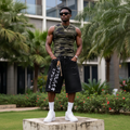Nigerian male model wearing men's black graffiti script print rhinestone star denim shorts streetwear style