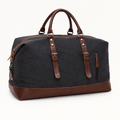 Charcoal travel duffel bag with brown trim and riveted handles
