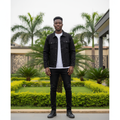 Nigerian male model wearing all-black denim trucker jacket