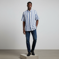 Nigerian male model wearing blue and white stripe short-sleeved shirt