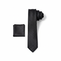 Men's black tonal micro-texture woven necktie and pocket square set flat lay product shot
