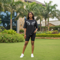 Nigerian female model wearing black oversized short sleeve tee with white headphone graphic print