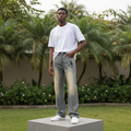 Nigerian male model full body wearing men's vintage washed embroidered wide-leg flared jeans