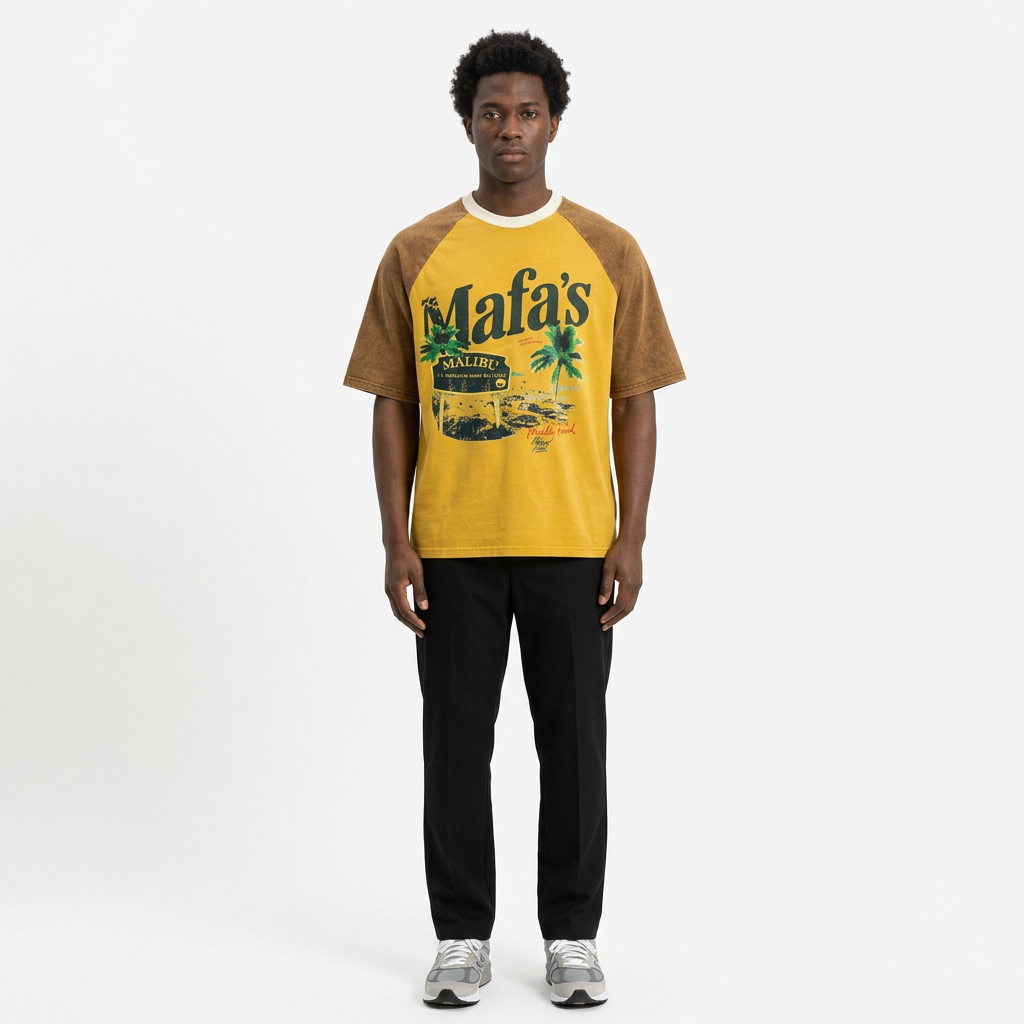 Full-body adult Black man wearing a yellow and brown graphic raglan T-shirt